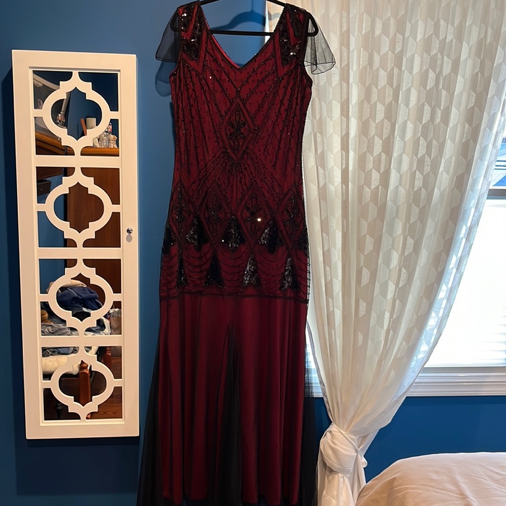 Red gown with black beads. Fully lined. 64” from shoulder to hem. Side zipper.